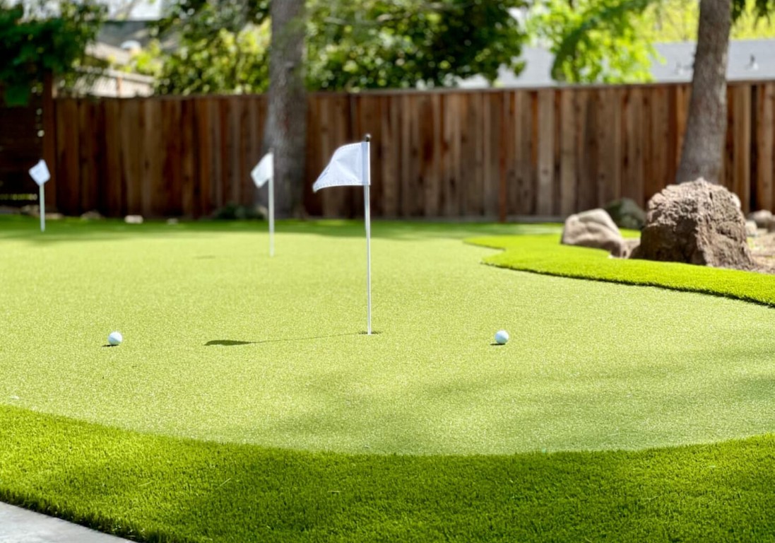 Custom backyard putting green installation with flags in Richland, WA
